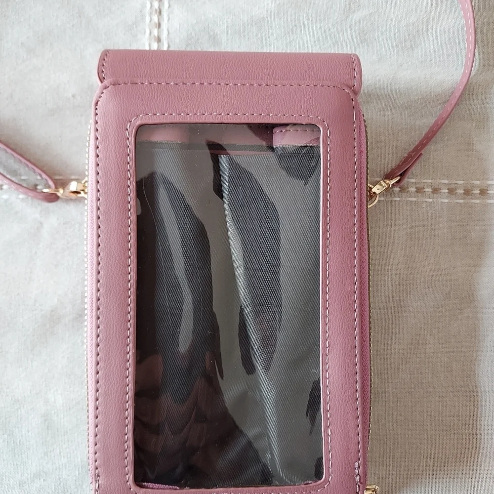 Roulens over shoulder or clutch wallet with cell phone holder.